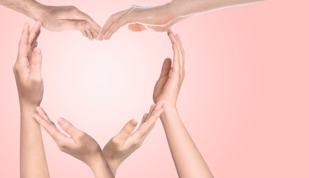 Image of People making heart shape with hands on pink background, banner design with space for text. Teamwork, unity, togetherness