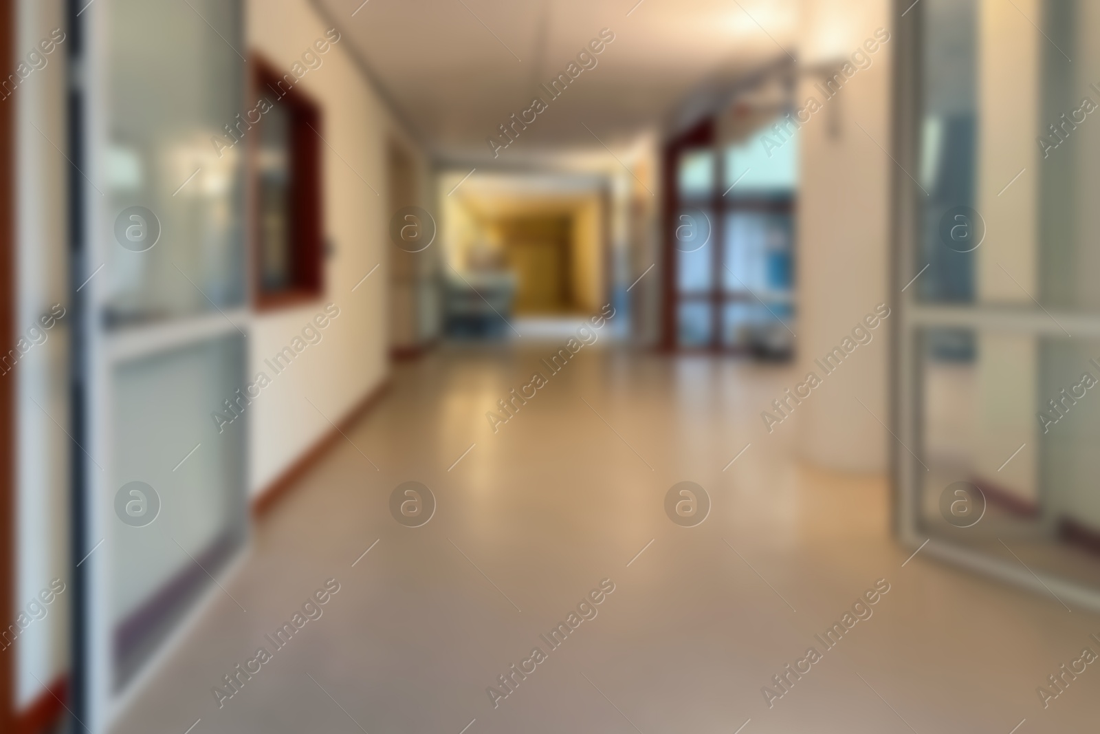 Image of Blurred view of empty corridor with glass doors