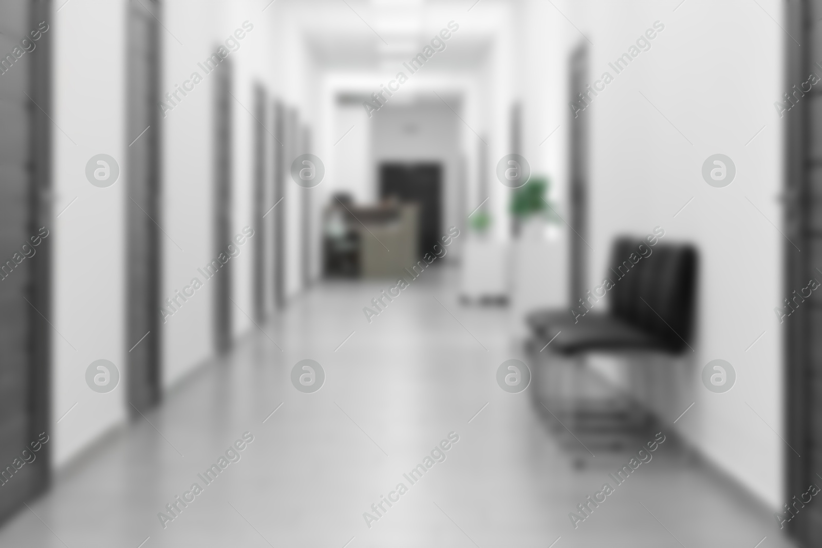 Image of Blurred view of empty corridor with doors and chairs