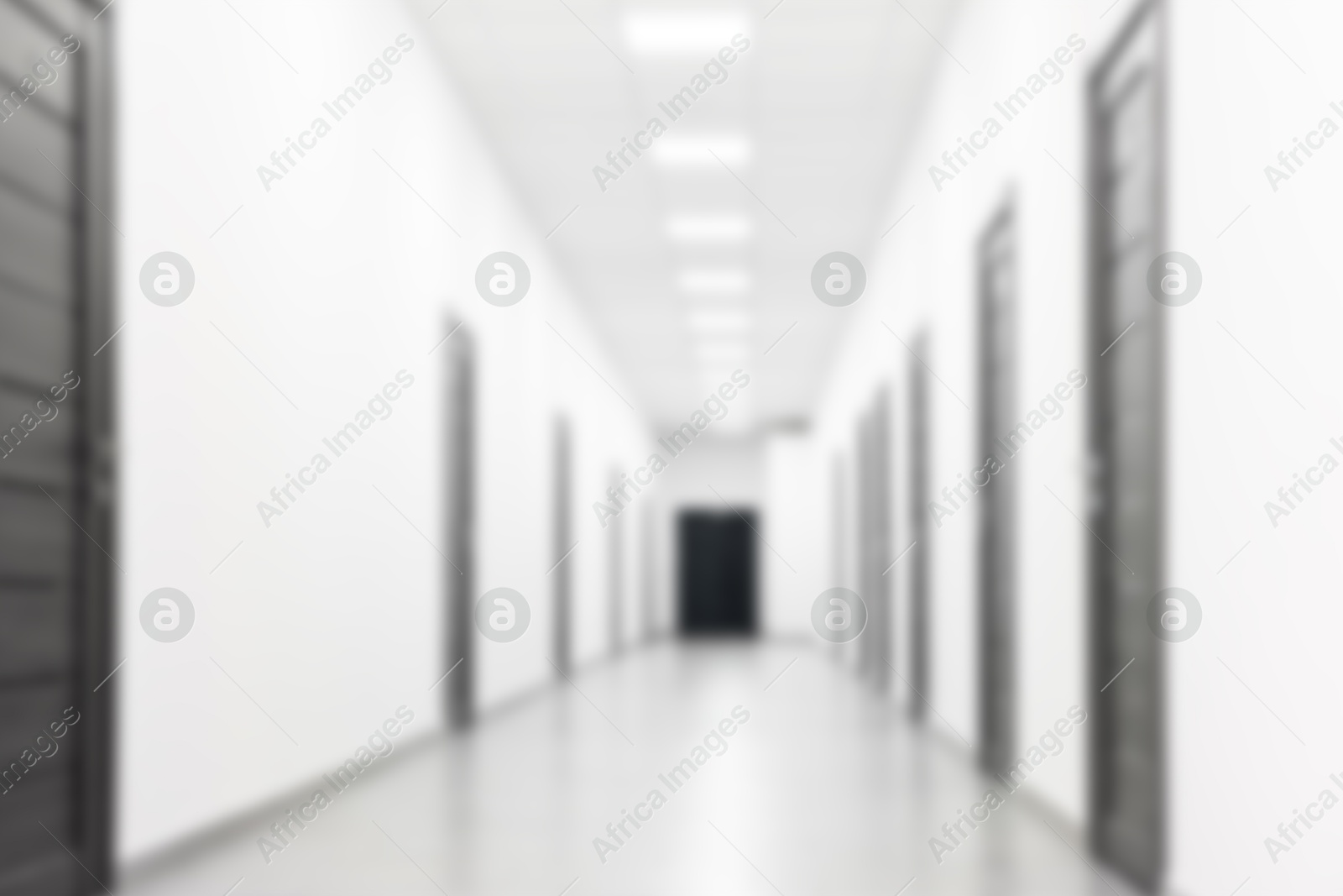 Image of Blurred view of empty corridor with doors