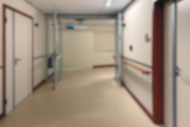 Image of Blurred view of empty hospital corridor with doors