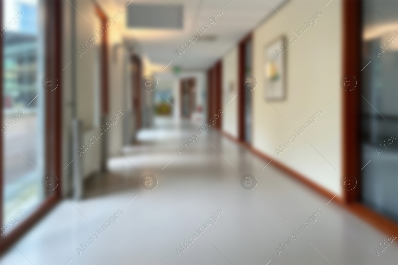 Image of Blurred view of empty corridor with glass doors