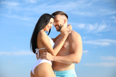 Photo of Happy young couple in beachwear on sunny day