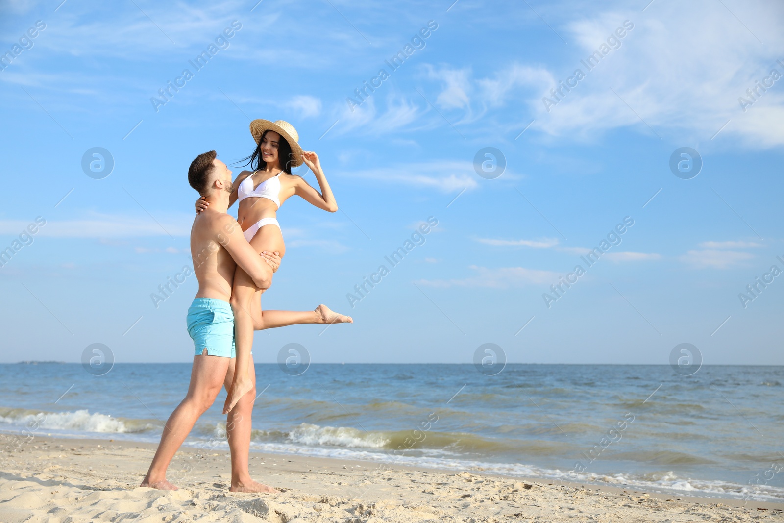 Photo of Happy young couple having fun on beach