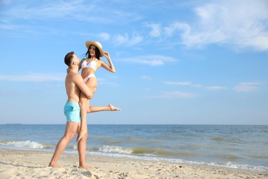 Photo of Happy young couple having fun on beach