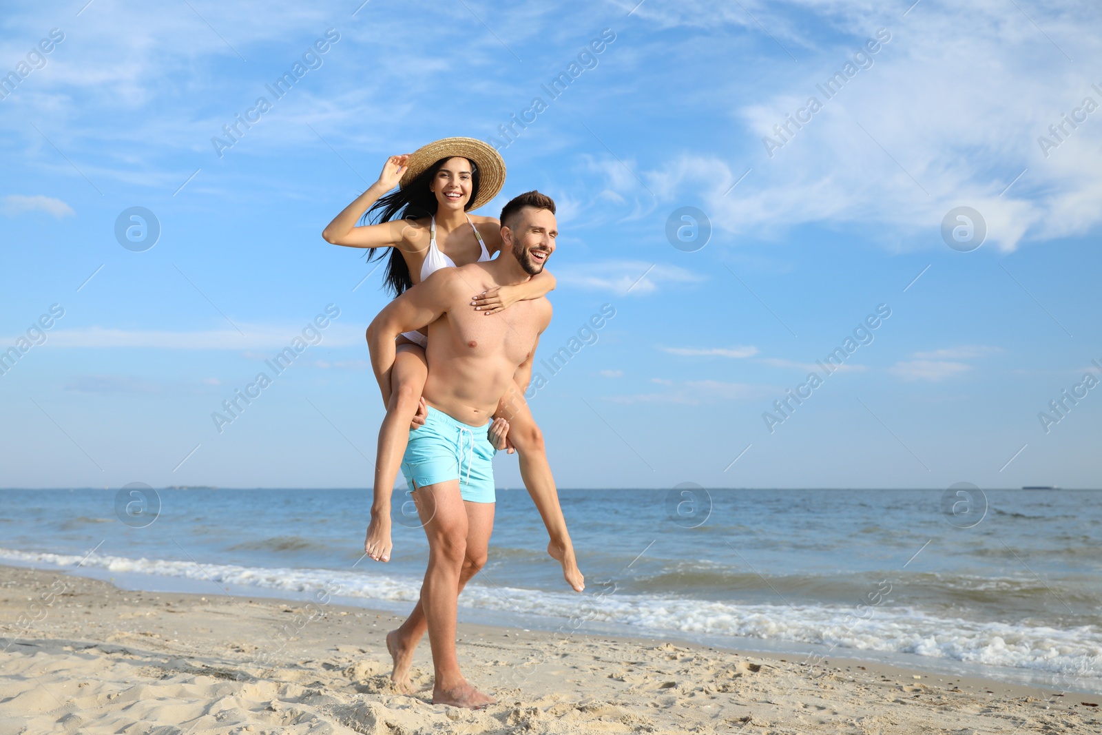 Photo of Happy young couple having fun on beach