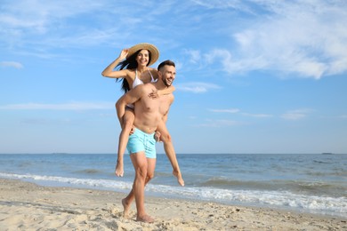 Photo of Happy young couple having fun on beach