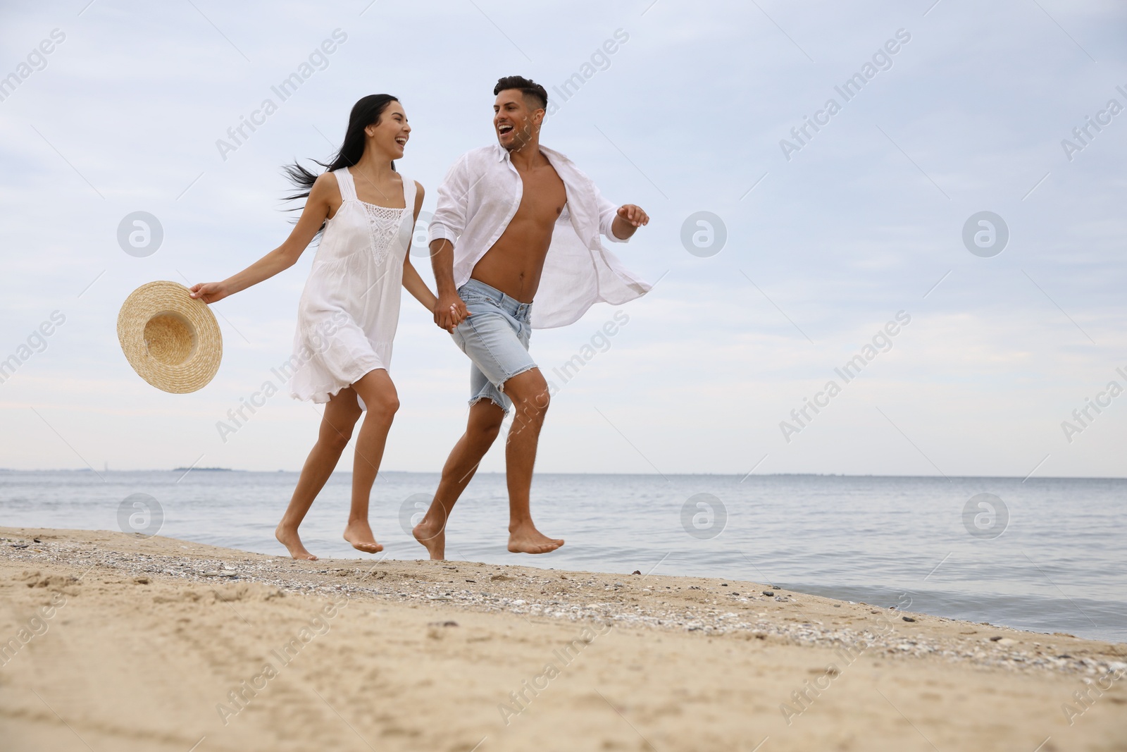 Photo of Lovely couple having fun on beautiful beach. Space for text