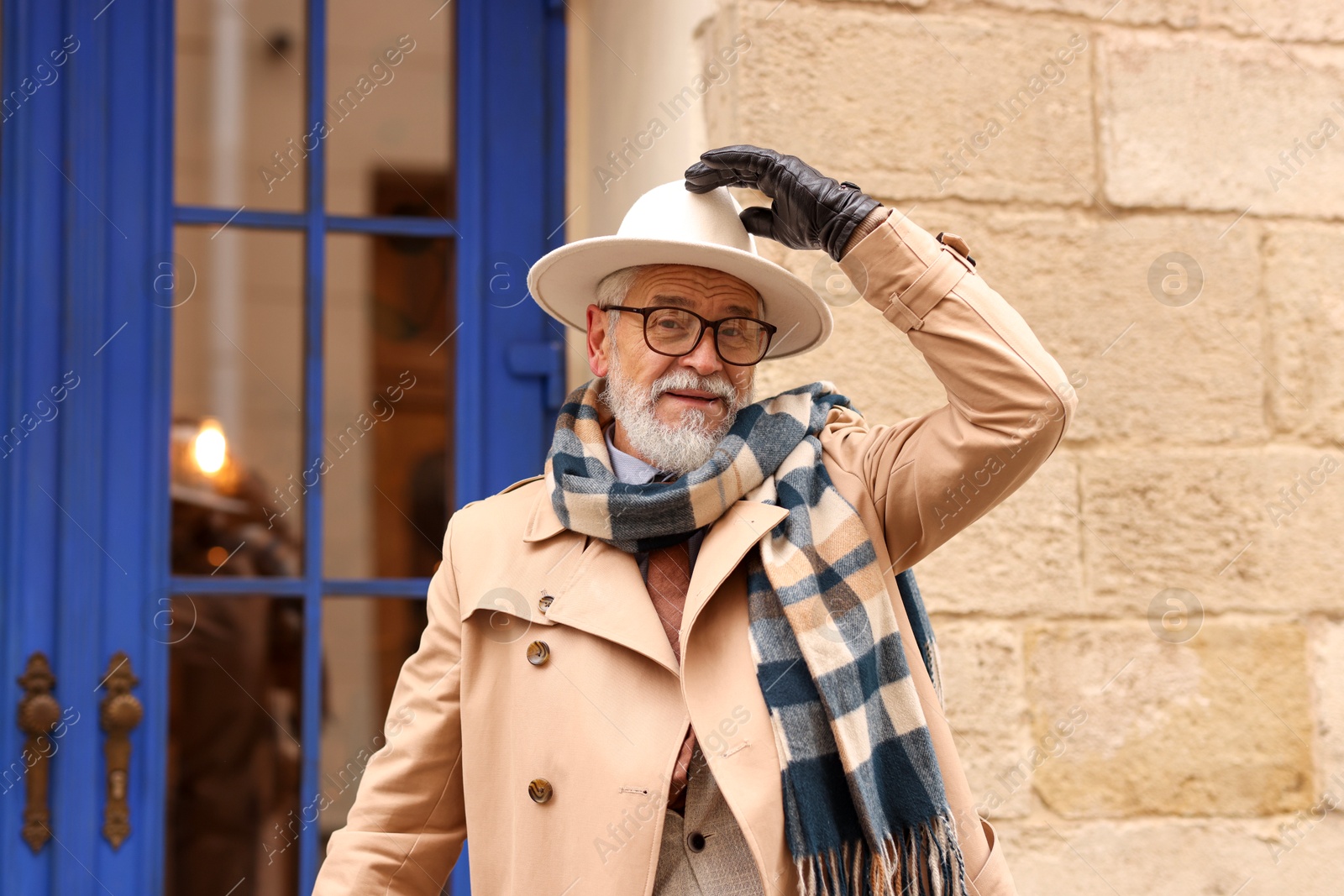 Photo of Stylish bearded senior man on city street