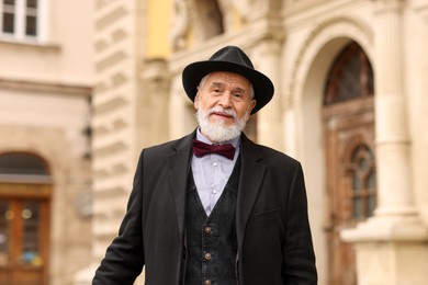 Photo of Elegant bearded senior man on city street