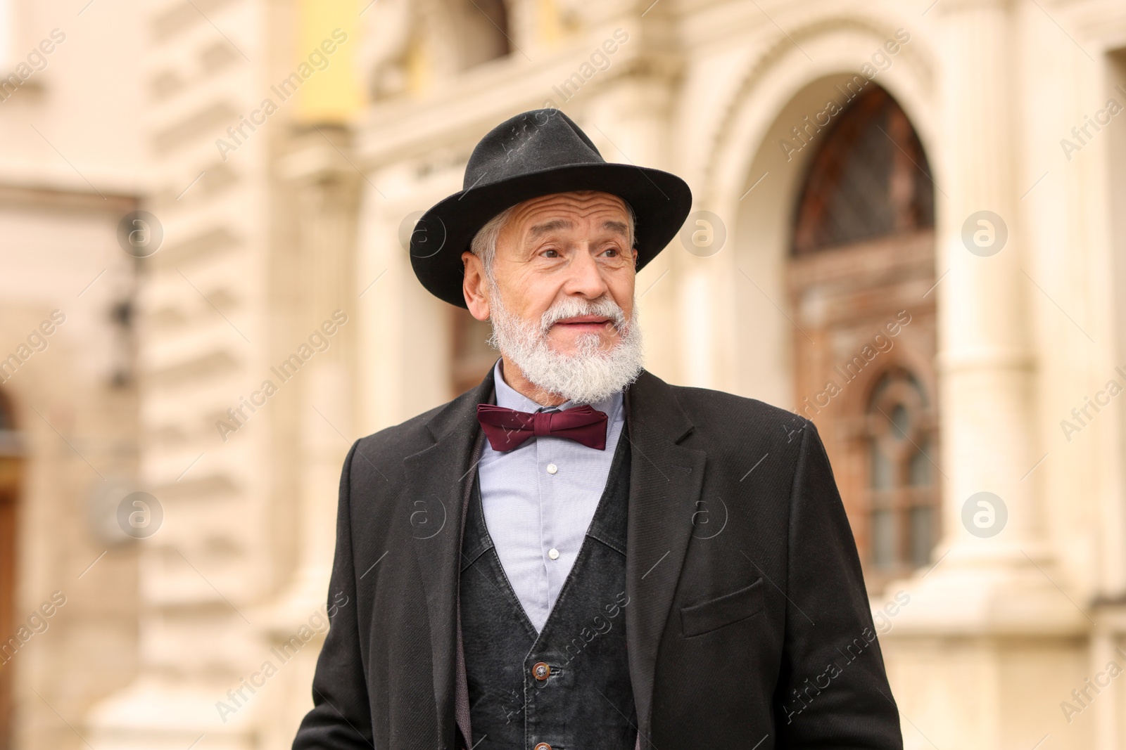 Photo of Elegant bearded senior man on city street