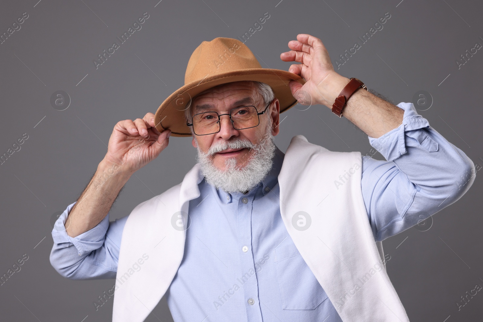 Photo of Bearded senior man with stylish hat on grey background