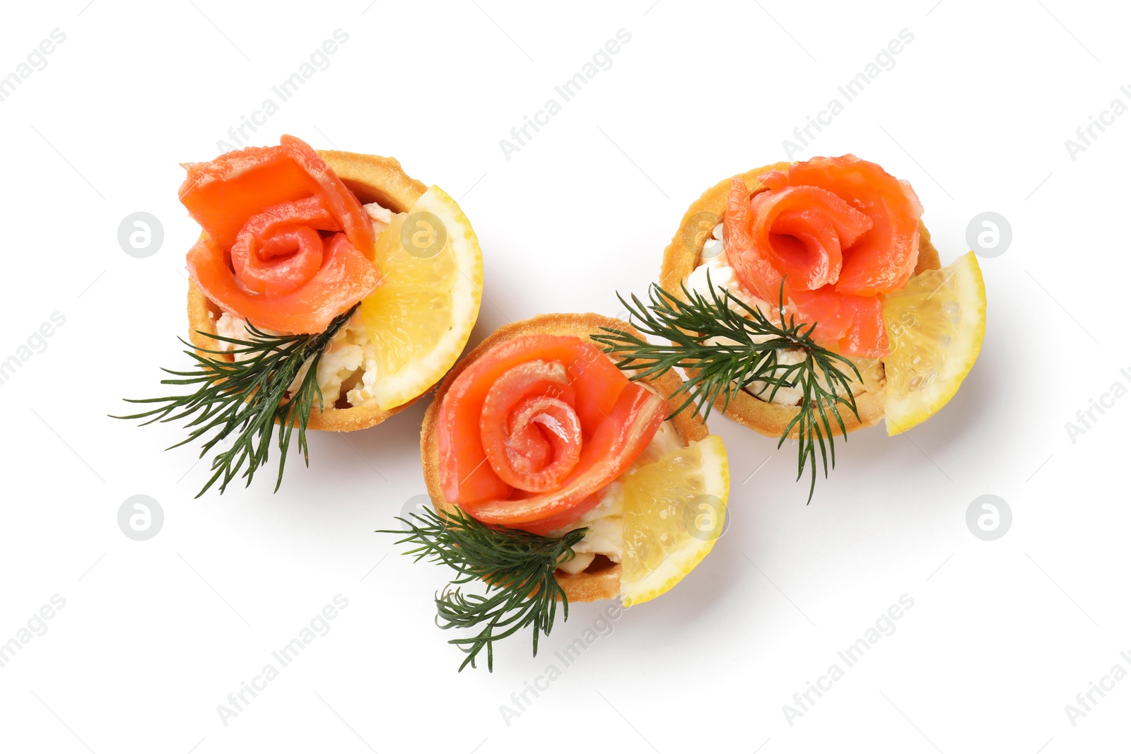 Photo of Tasty tartlets with salmon, lemon and dill isolated on white, top view