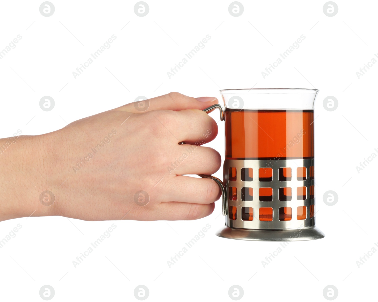 Photo of Woman holding glass of aromatic tea in holder on white background, closeup