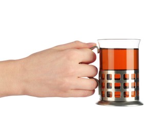 Photo of Woman holding glass of aromatic tea in holder on white background, closeup