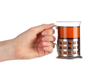 Woman holding glass of aromatic tea in holder on white background, closeup