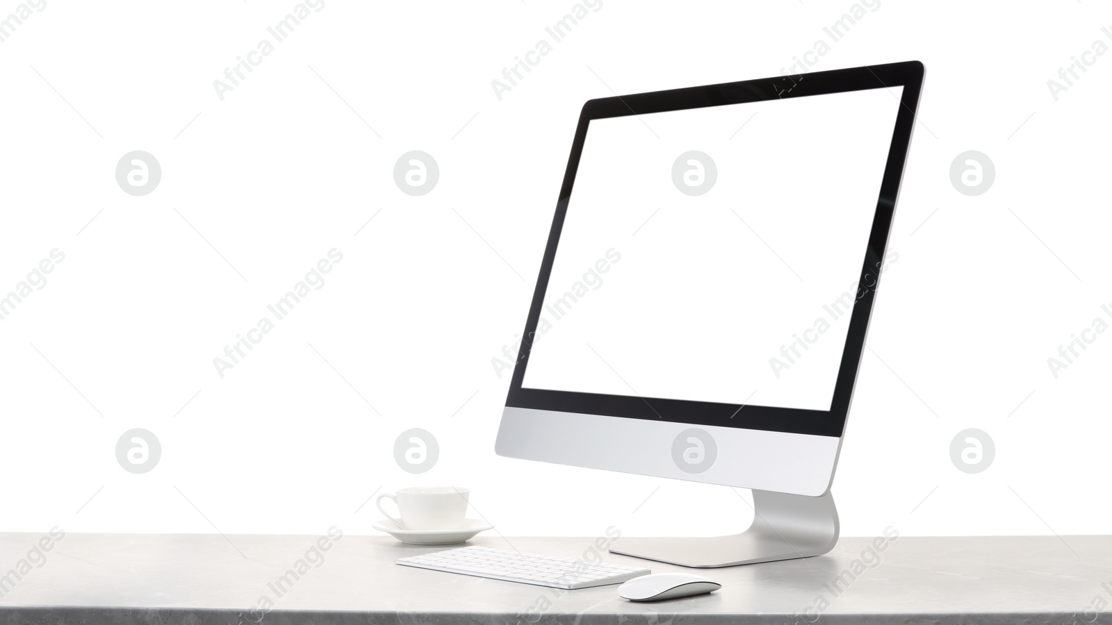 Photo of Computer monitor, keyboard, mouse and cup of drink on grey desk against white background