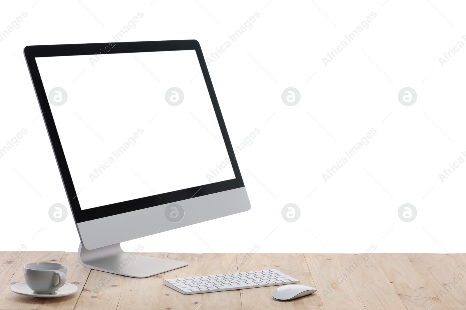 Photo of Computer monitor, keyboard, mouse and cup of drink on wooden desk against white background