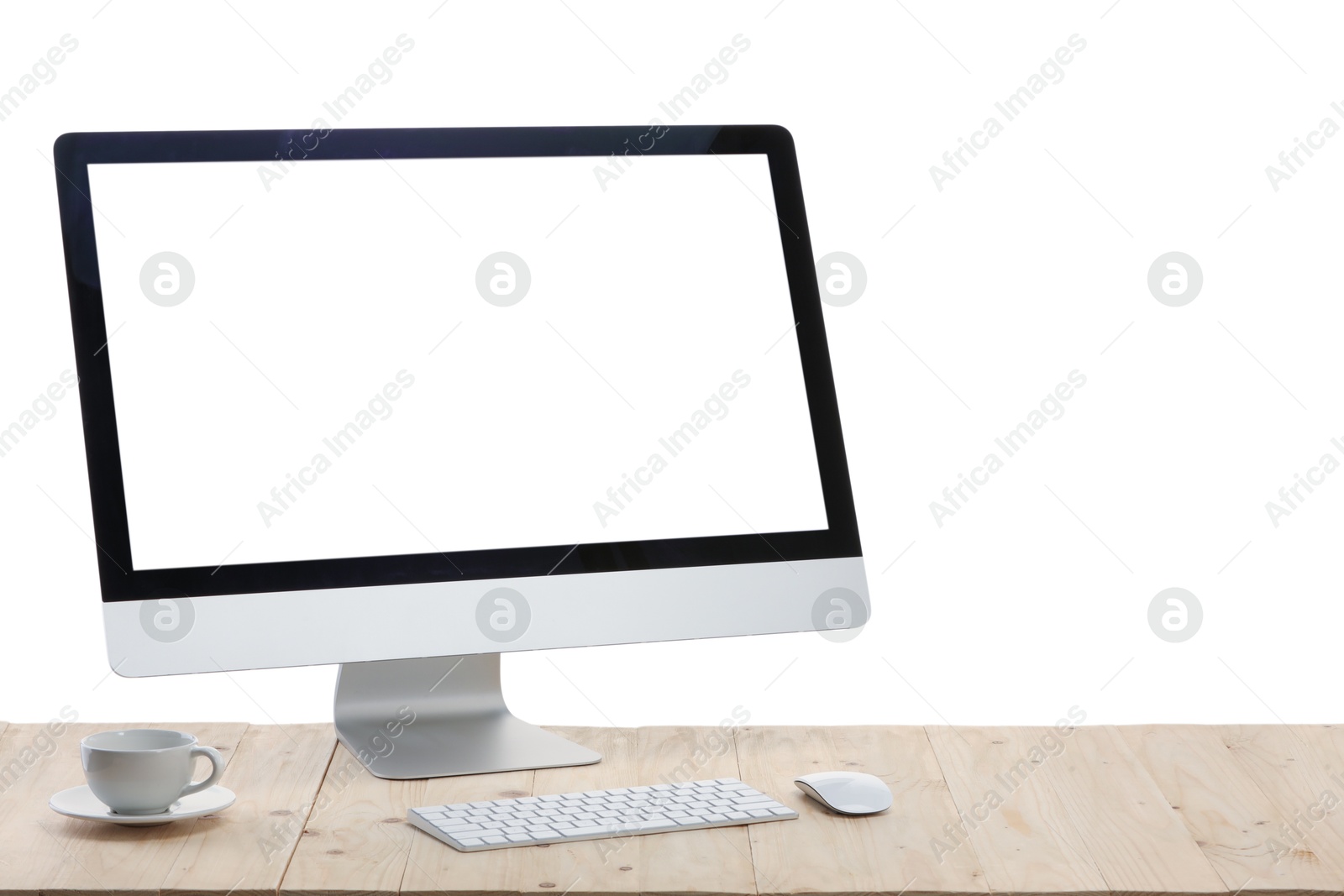 Photo of Computer monitor, keyboard, mouse and cup of drink on wooden desk against white background