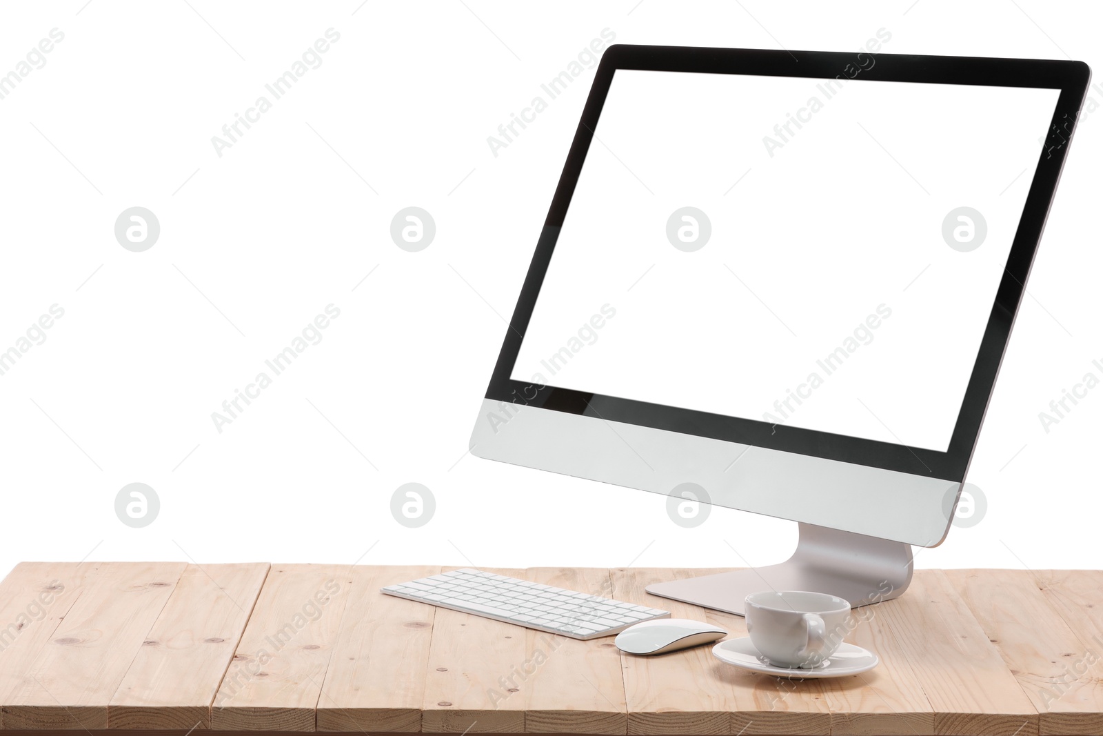 Photo of Computer monitor, keyboard, mouse and cup of drink on wooden desk against white background