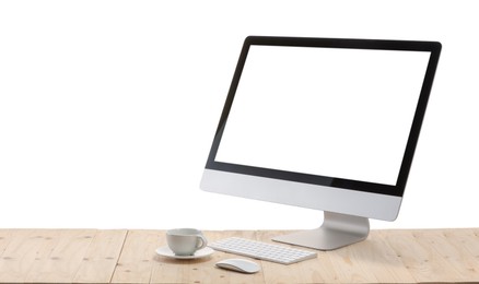 Photo of Computer monitor, keyboard, mouse and cup of drink on wooden desk against white background