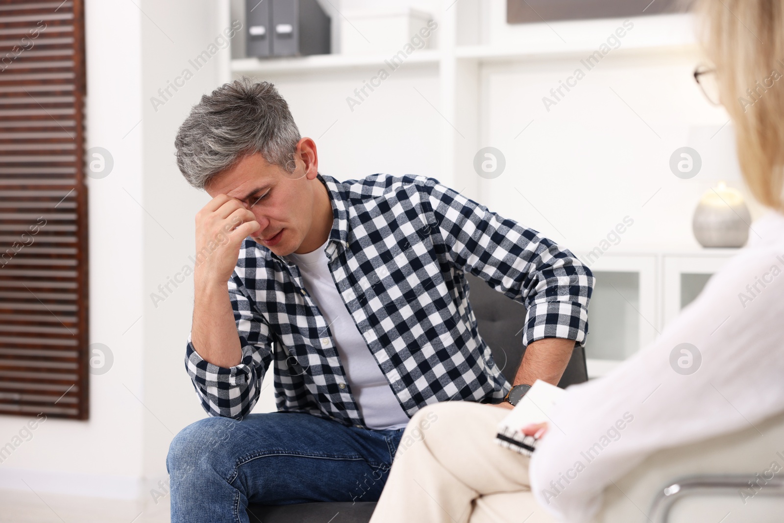 Photo of Professional psychologist working with patient in office, closeup