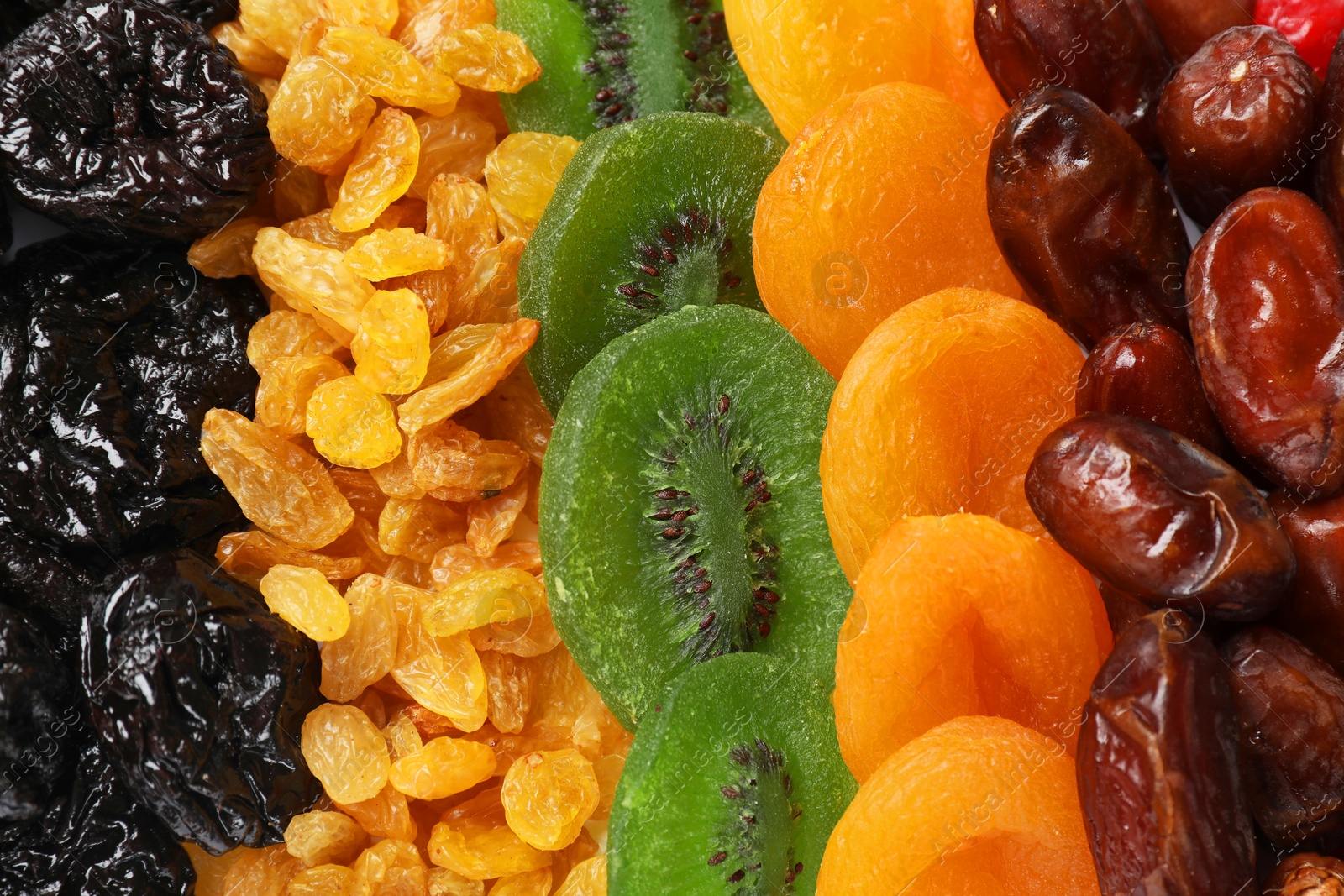 Photo of Different dried fruits as background, top view