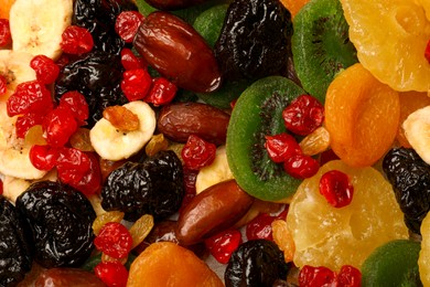 Photo of Mix of different dried fruits as background, top view