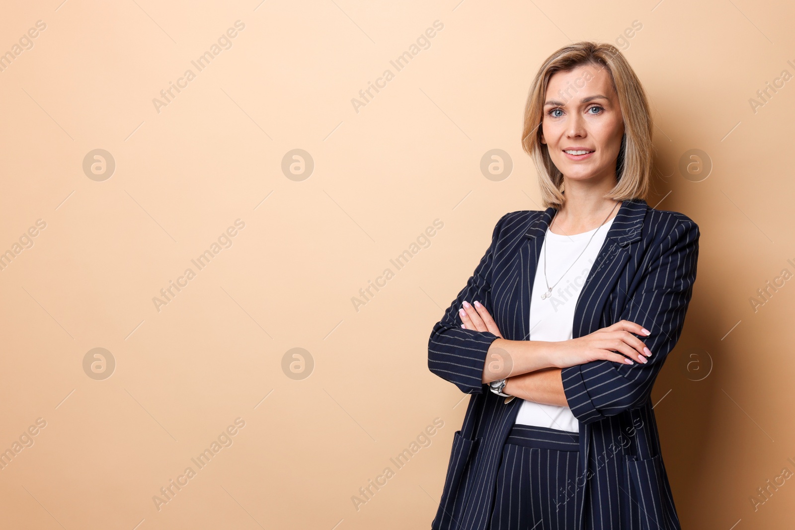 Photo of Portrait of businesswoman on beige background, space for text