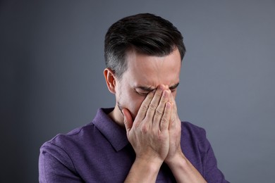 Photo of Portrait of sad man crying on grey background