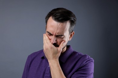 Photo of Portrait of sad man crying on grey background