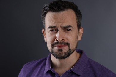 Photo of Portrait of sad man crying on grey background