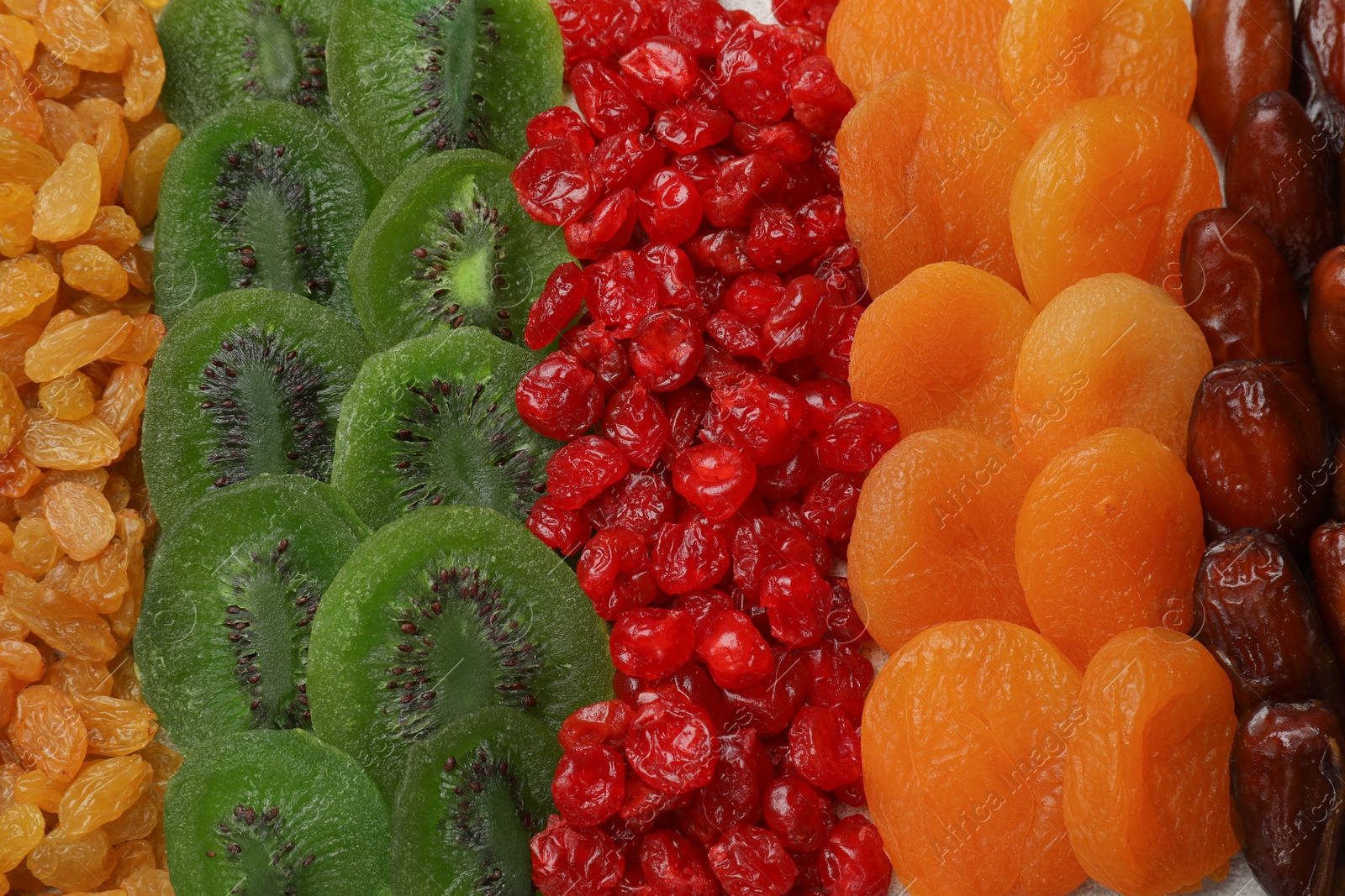 Photo of Different dried fruits as background, top view