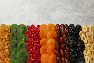 Photo of Different dried fruits on grey table, top view. Space for text