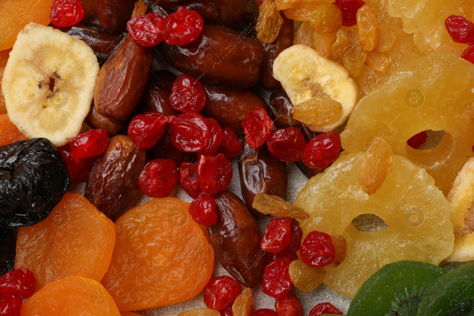 Photo of Mix of different dried fruits as background, closeup