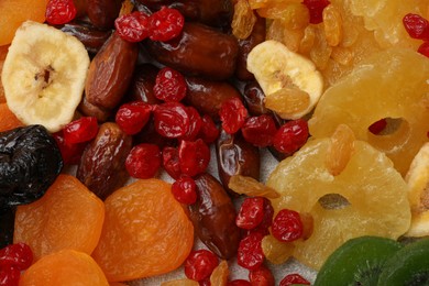 Photo of Mix of different dried fruits as background, closeup