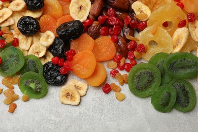 Photo of Mix of different dried fruits on grey table, top view