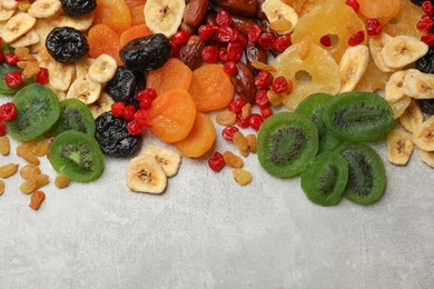 Photo of Mix of different dried fruits on grey table, top view