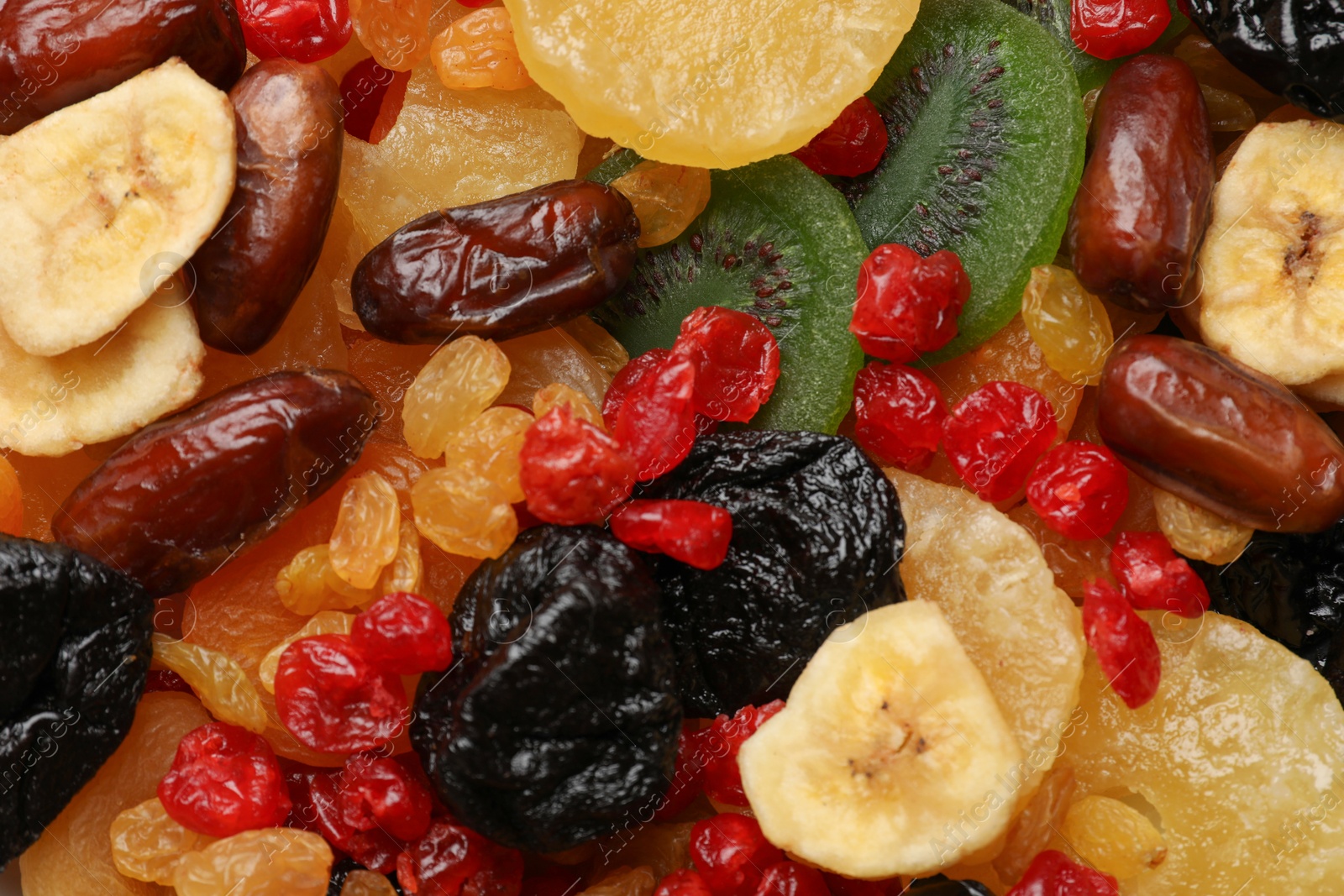 Photo of Mix of different dried fruits as background, closeup