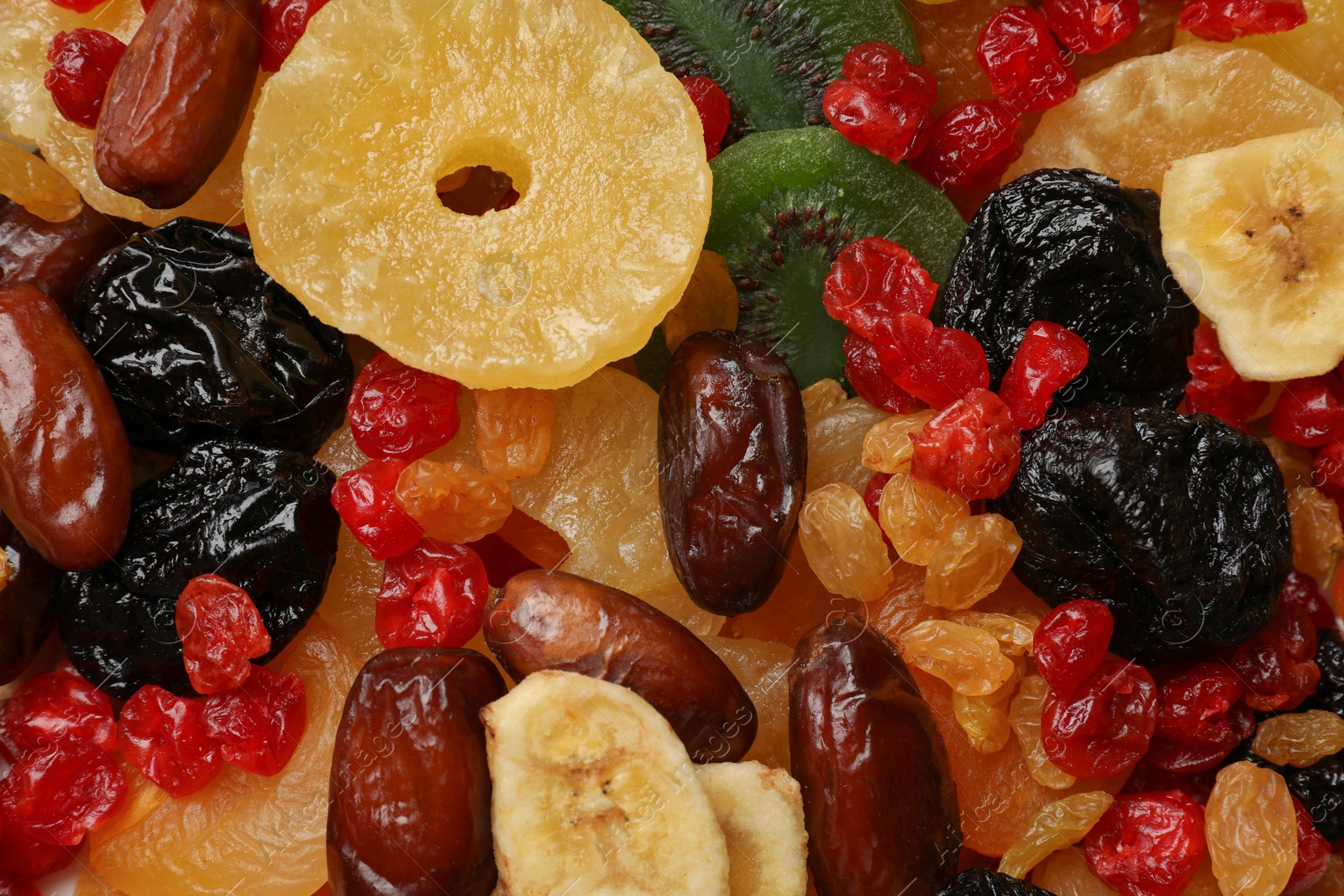 Photo of Mix of different dried fruits as background, closeup