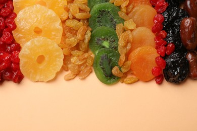 Photo of Different dried fruits on beige background, top view. Space for text