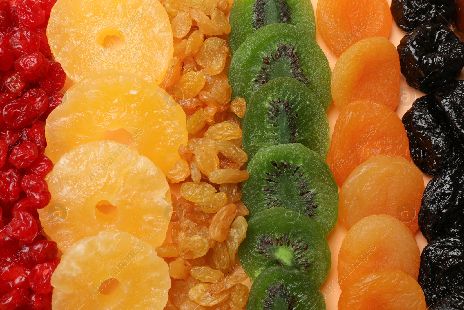 Photo of Different dried fruits as background, top view