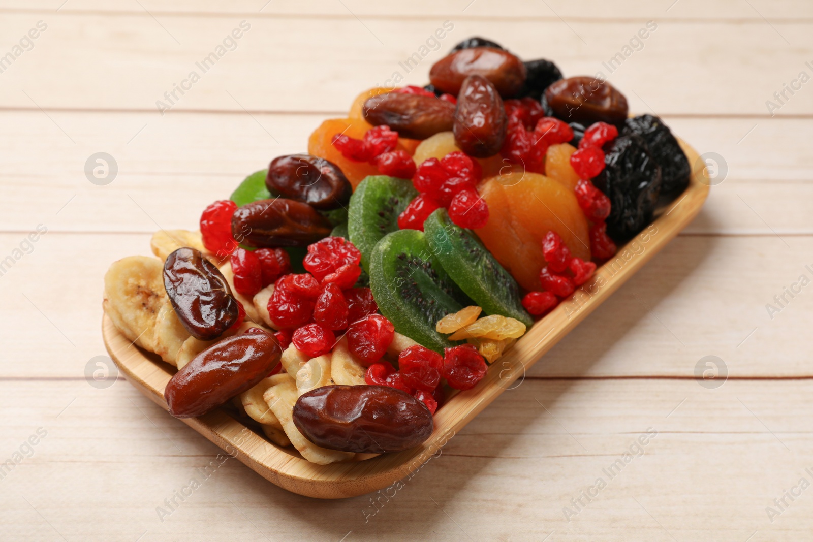 Photo of Different dried fruits on white wooden table, closeup