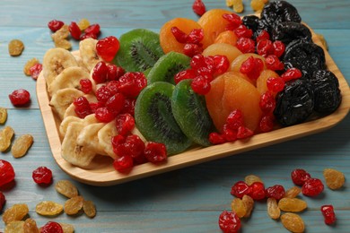 Photo of Different dried fruits on blue wooden table, closeup