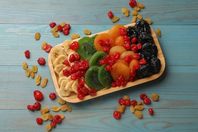 Photo of Different dried fruits on blue wooden table, top view