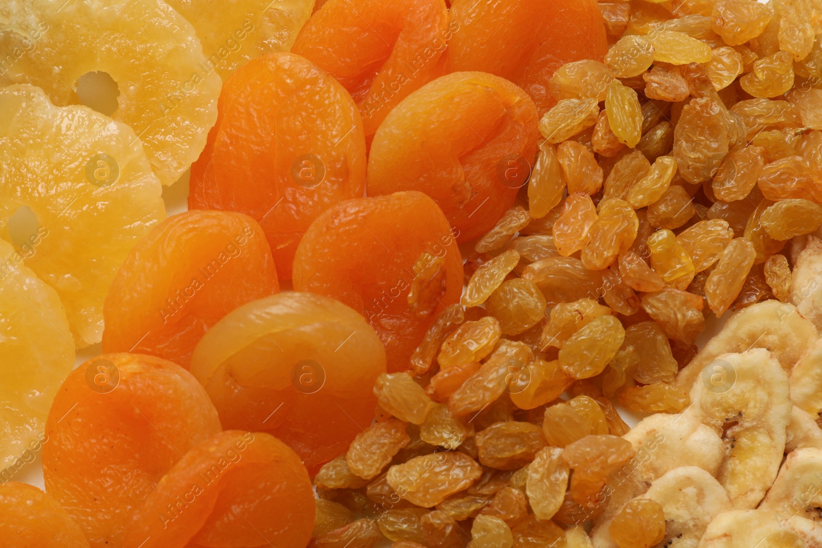 Photo of Different dried fruits as background, top view