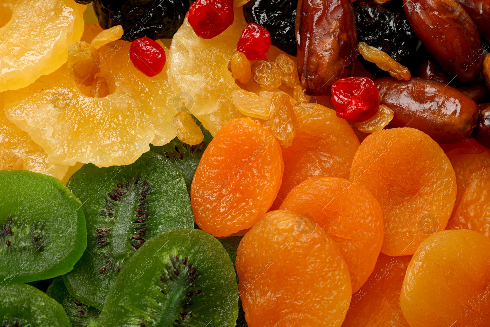 Photo of Mix of different dried fruits as background, closeup