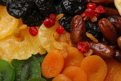 Photo of Mix of different dried fruits as background, closeup