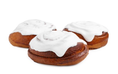 Photo of Tasty cinnamon rolls with cream isolated on white