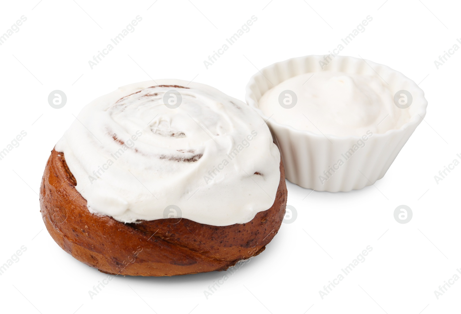 Photo of Tasty cinnamon roll with cream isolated on white